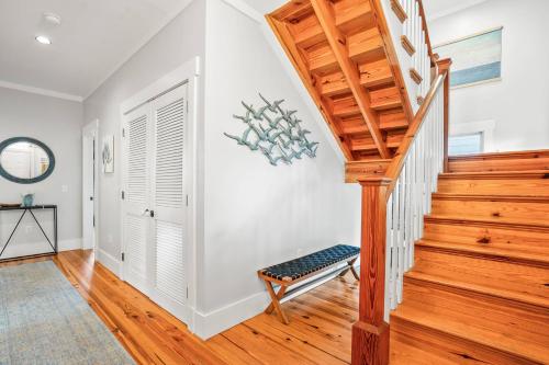 a staircase in a home with white walls and wooden floors at Fripp Island 94 Davis Love Dr in Fripp Island