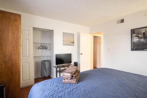 a bedroom with a blue bed and a television at 2 bedroom UNLV, Thomas Mack in Las Vegas