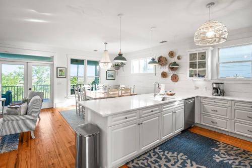 a kitchen with white cabinets and a dining room at Fripp Island 94 Davis Love Dr in Fripp Island