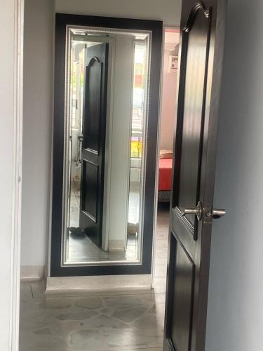 an open door with a mirror in a room at Apartamento amoblado in Neiva