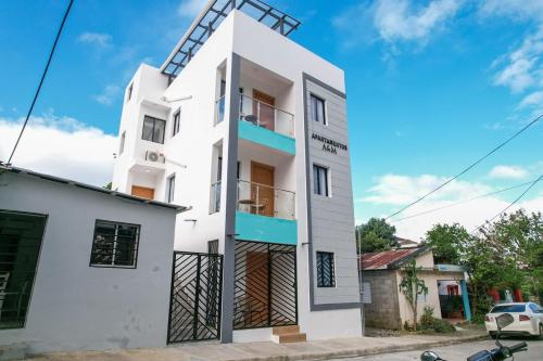 a white building with a windmill on top at From A & M Luxury Apartment at the Beach in Río San Juan