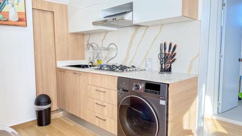 a kitchen with a washing machine in a kitchen at From A & M Luxury Apartment at the Beach in Río San Juan