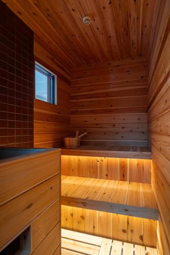 a sauna with wood paneling and a window at Private Villa 3 minutes from bus stop - in the meantime in Hakone