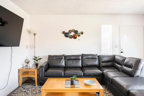 a living room with a leather couch and a table at MGM Airport Strip 2 miles in Las Vegas