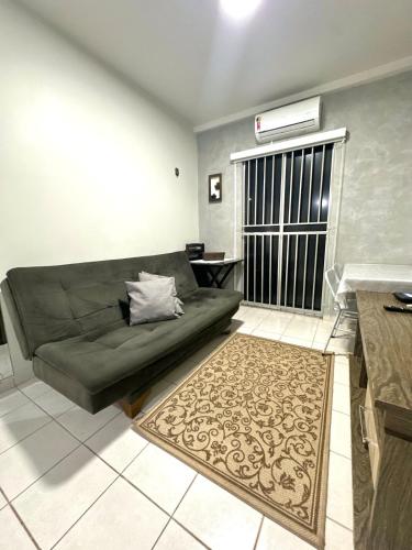 a living room with a couch and a rug at APT Davisis 11 Tom Jobim - Px Praça Girassóis, Av JK e Detran in Palmas