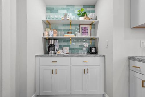 a kitchen with white cabinets and a counter top at Royal Flush-6 King Beds-18 Mi To Mohegan in Norwich
