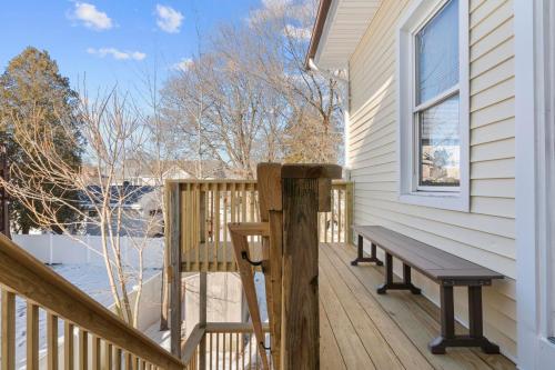 a wooden porch with a bench on a house at Royal Flush-6 King Beds-18 Mi To Mohegan in Norwich