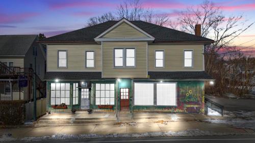 a large house with a front porch with lights on at Royal Flush-6 King Beds-18 Mi To Mohegan in Norwich