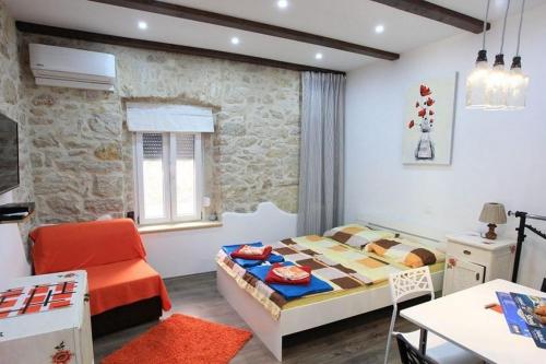 a small room with a bed and a table at Apartments by the sea Zablace, Sibenik - 24318 in Zablaće
