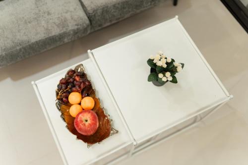 two plates of fruit on a white table at 2-Bedroom Elegant Condo - Butuan Retreat in Butuan