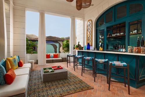 a living room with a bar with blue cabinets at Santarena Hotel at Las Catalinas in Playa Flamingo