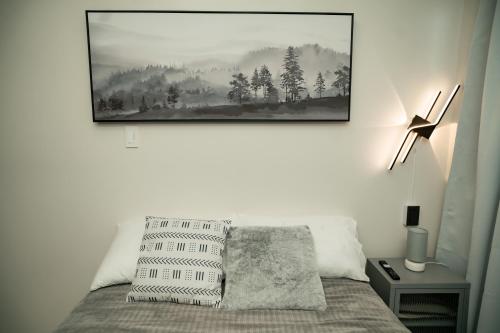 a bedroom with a bed with a picture on the wall at 2-Bedroom Elegant Condo - Butuan Retreat in Butuan