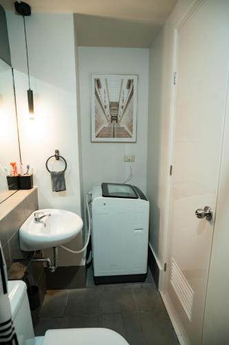 a bathroom with a white toilet and a sink at 2-Bedroom Elegant Condo - Butuan Retreat in Butuan