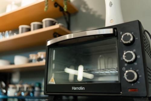 a microwave oven sitting on top of a counter at 2-Bedroom Elegant Condo - Butuan Retreat in Butuan