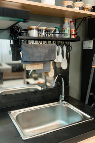 a kitchen counter with a sink and a mixer at 2-Bedroom Elegant Condo - Butuan Retreat in Butuan