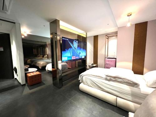 a hotel room with two beds and a tv at Yeoksam Lumiere Hotel in Seoul