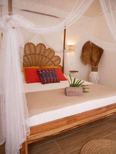 a bedroom with a bed with a wooden headboard at Coco Soley in Le Diamant