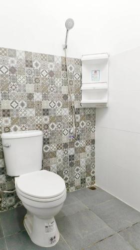 a bathroom with a toilet and a shower at Herritage Piman since 1940 in San Kamphaeng