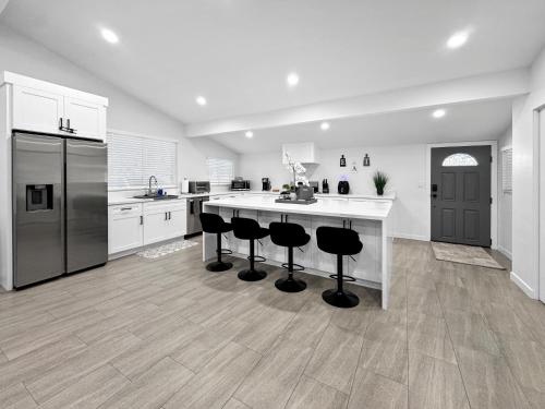 a kitchen with a large island with bar stools at Modern Home for Large Families by Disney & Knotts in Anaheim