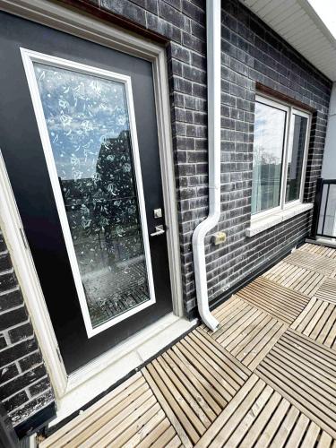 a front door of a house with a balcony at Modern Private Room Private Bathroom with King Bed with TV and Optional Balcony 10 minutes to Rogers Stadium Midtown Downtown Toronto in Toronto