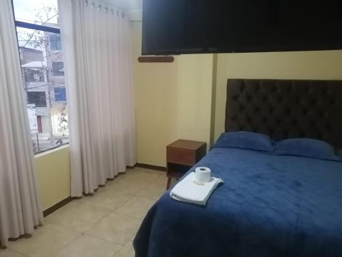 a bedroom with a blue bed with a tray on it at Hospedaje San Blas in San Antonio