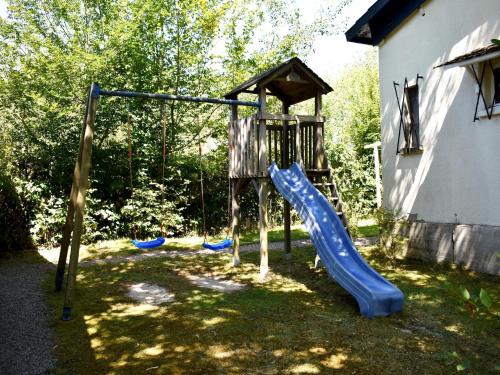 a playground with a slide in a yard at Holiday Home in St Honoré with Scenic Views in Saint-Honoré-les-Bains