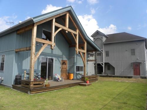a large blue barn with a porch on it at B&BHOUSE FAM - Vacation STAY 39468v in Ichinomiya