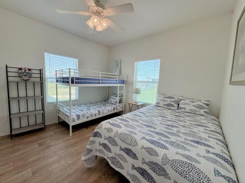 a bedroom with a bed and a ceiling fan at Sunburn Alley home in Caplen