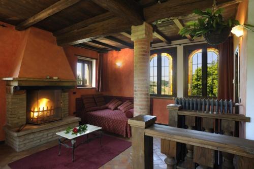 a living room with a couch and a fireplace at Agriturismo La Fenice in Tolè