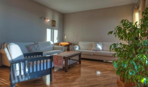 a living room with two couches and a coffee table at Guest house Živković in Sveti Stefan