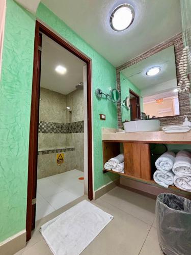 a bathroom with a shower and a sink and a mirror at Loft Yol-Kin Bacalar in Bacalar