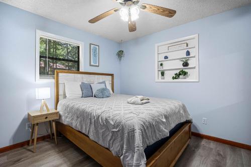 a bedroom with a bed and a ceiling fan at Red Rock Ranch in Cosby