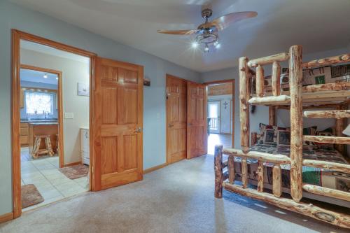 a bedroom with two bunk beds and a ceiling fan at Smoky Mountain Getaway in Cosby
