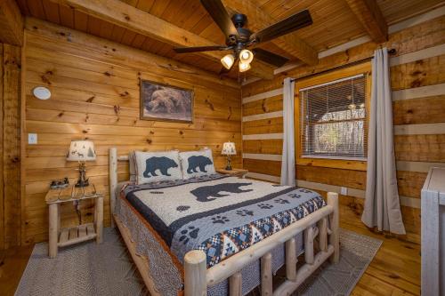 a bedroom with a bed in a log cabin at Hidden Hideaway in Cosby
