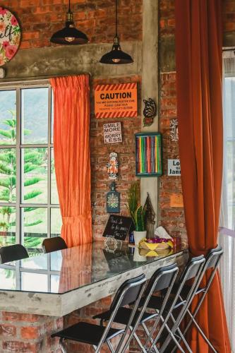 a dining room with a table and chairs at Mimi's Pine Meadow - Where it Nourishes Our Souls in Pulau Langkawi