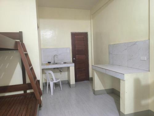 a small room with a sink and a desk at The Stopover at Bangui Windmills in Bangui