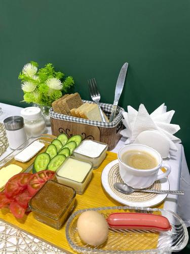 a table with cheese and bread and a cup of coffee at RUNO inn Hotel in Baku
