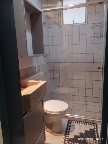 a bathroom with a toilet and a sink at Mi casa su casa 3 in Londrina