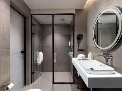 a bathroom with a sink and a mirror at Mercure Chandigarh Tribune Chowk in Chandīgarh