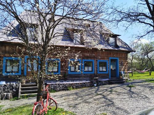 a red bike parked in front of a house at Breb s Cosy Barn in Breb