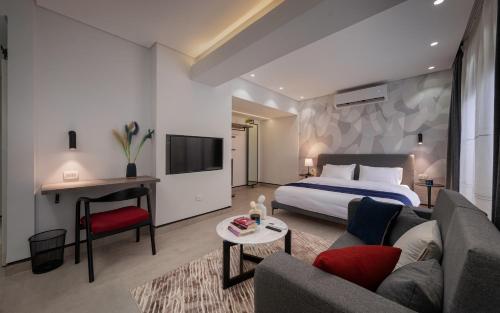 a hotel room with a bed and a couch at Exclusive stay with luxury touches at 22 by spacey #55 Studio in Maadi in Cairo