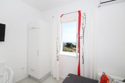 a room with a window and a white curtain at Apartment LU in Split