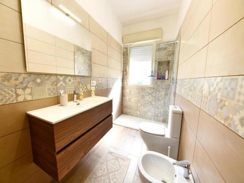 a bathroom with a sink and a toilet at Villa with private pool in Floridia