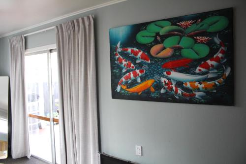 a painting of kites on a wall in a living room at Beautiful home with short stroll to Havelock Village in Havelock North
