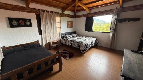 Postel nebo postele na pokoji v ubytování Finca Hotel Paraiso Urrao