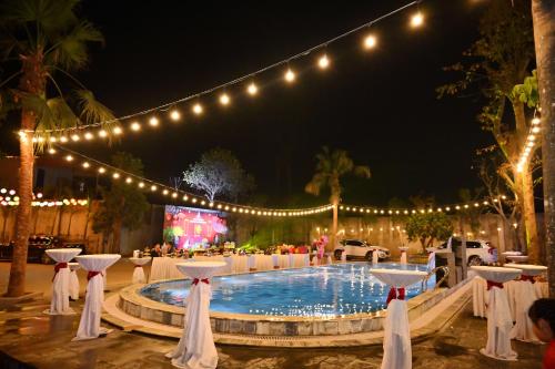 a party with lights and a pool at night at King Hill Vila in Sơn Tây