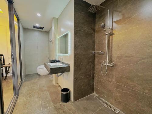 a bathroom with a shower and a sink at King Hill Vila in Sơn Tây