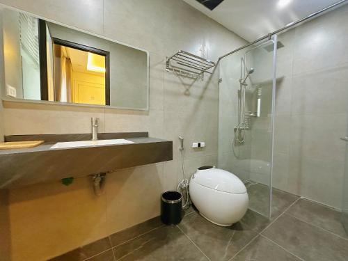 a bathroom with a sink and a glass shower at King Hill Vila in Sơn Tây