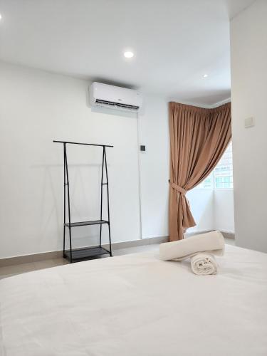 a white room with a bed and a window at Rawang Home near Aeon 15 Pax WIFI Game Smart TV in Rawang