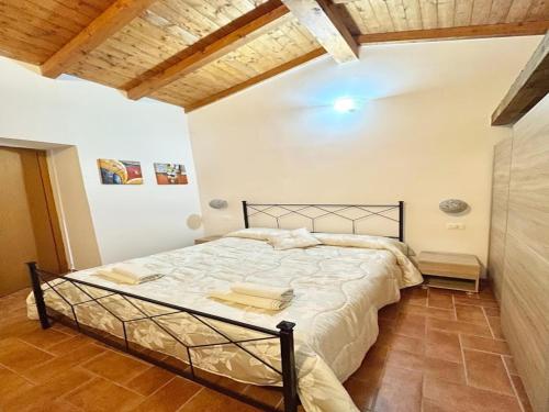 a bedroom with a large bed in a room at Holiday Home in Sicily with Pool & Etna Views in Francavilla di Sicilia